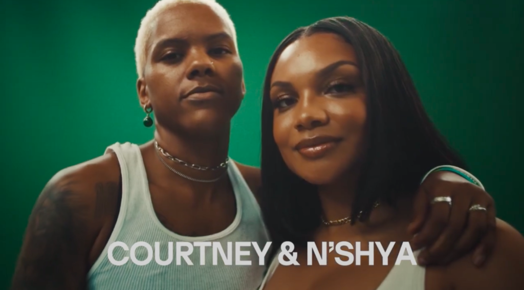 Courtney Williams with her arm around her girlfriend N'Shya, both of them looking at the camera