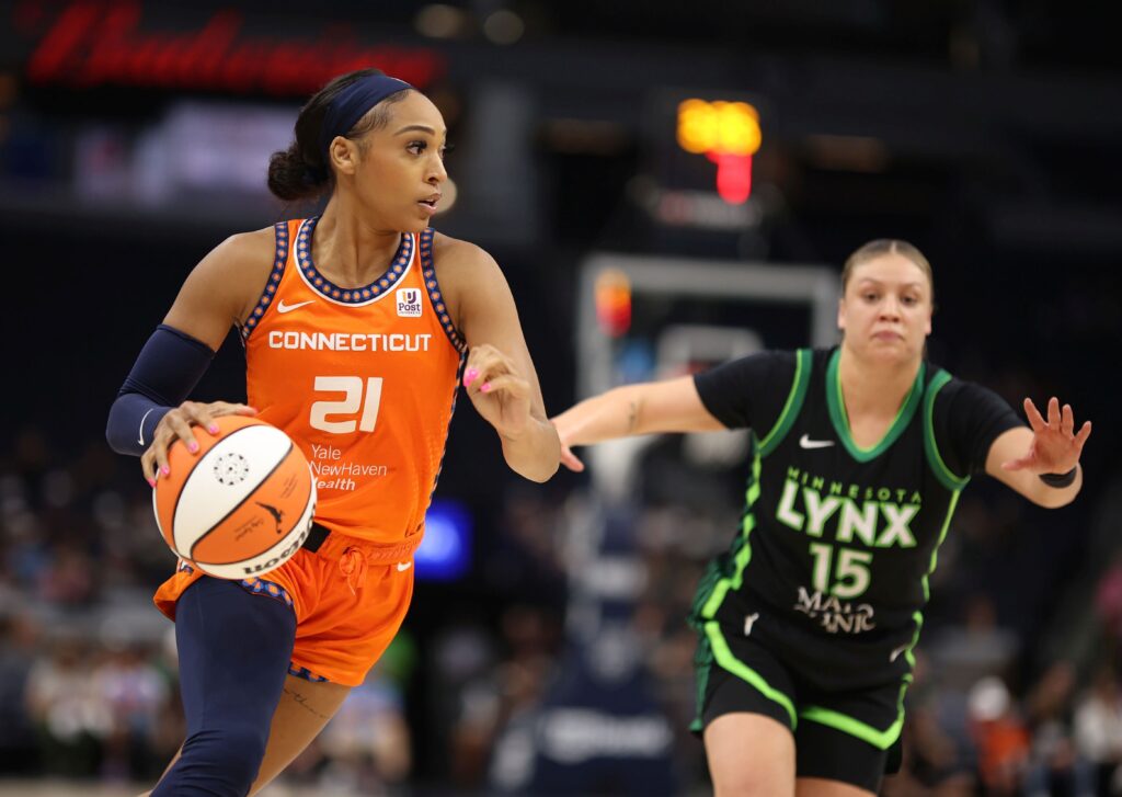 DiJonai Carrington dribbling with the ball while Rachel Banham of the Minnesota Lynx comes up to guard her