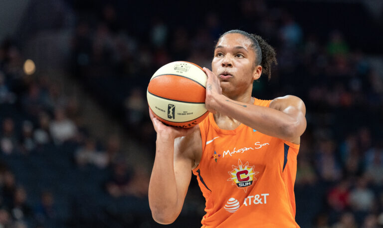 Alyssa Thomas of the Connecticut Sun taking a free throw with one hand under the ball and the other on the side.